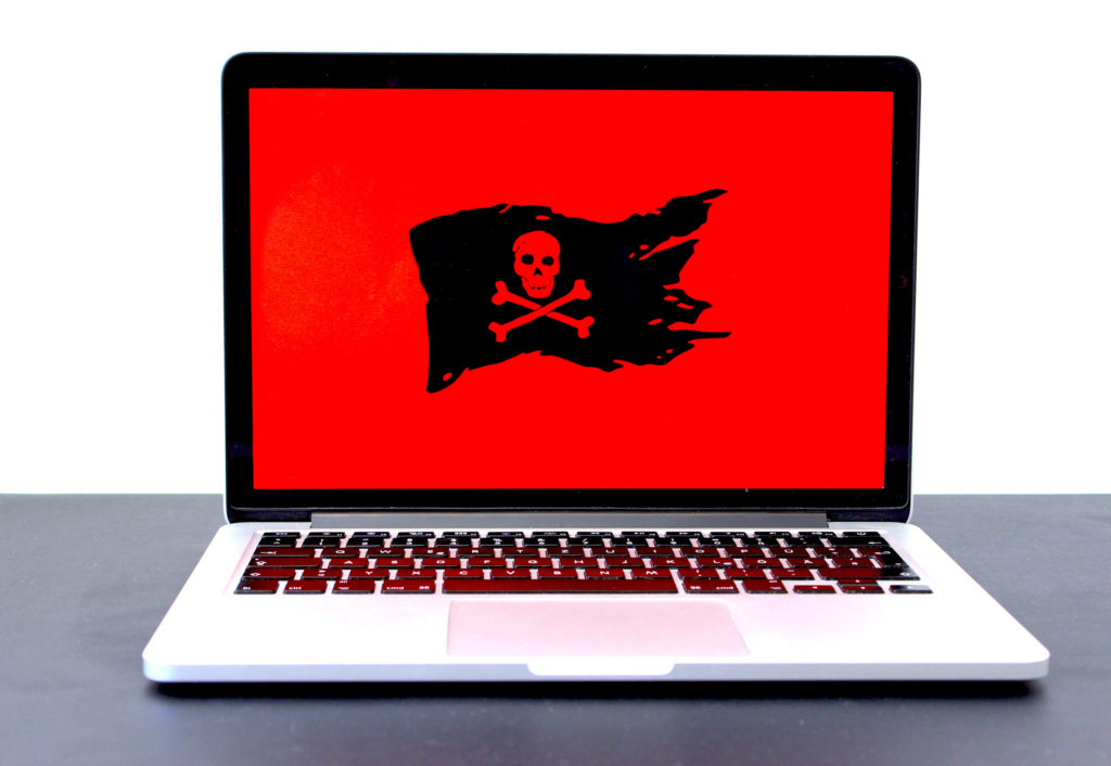 Laptop computer with a red screen and pirate Jolly Roger flag