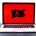 Laptop computer with a red screen and pirate Jolly Roger flag