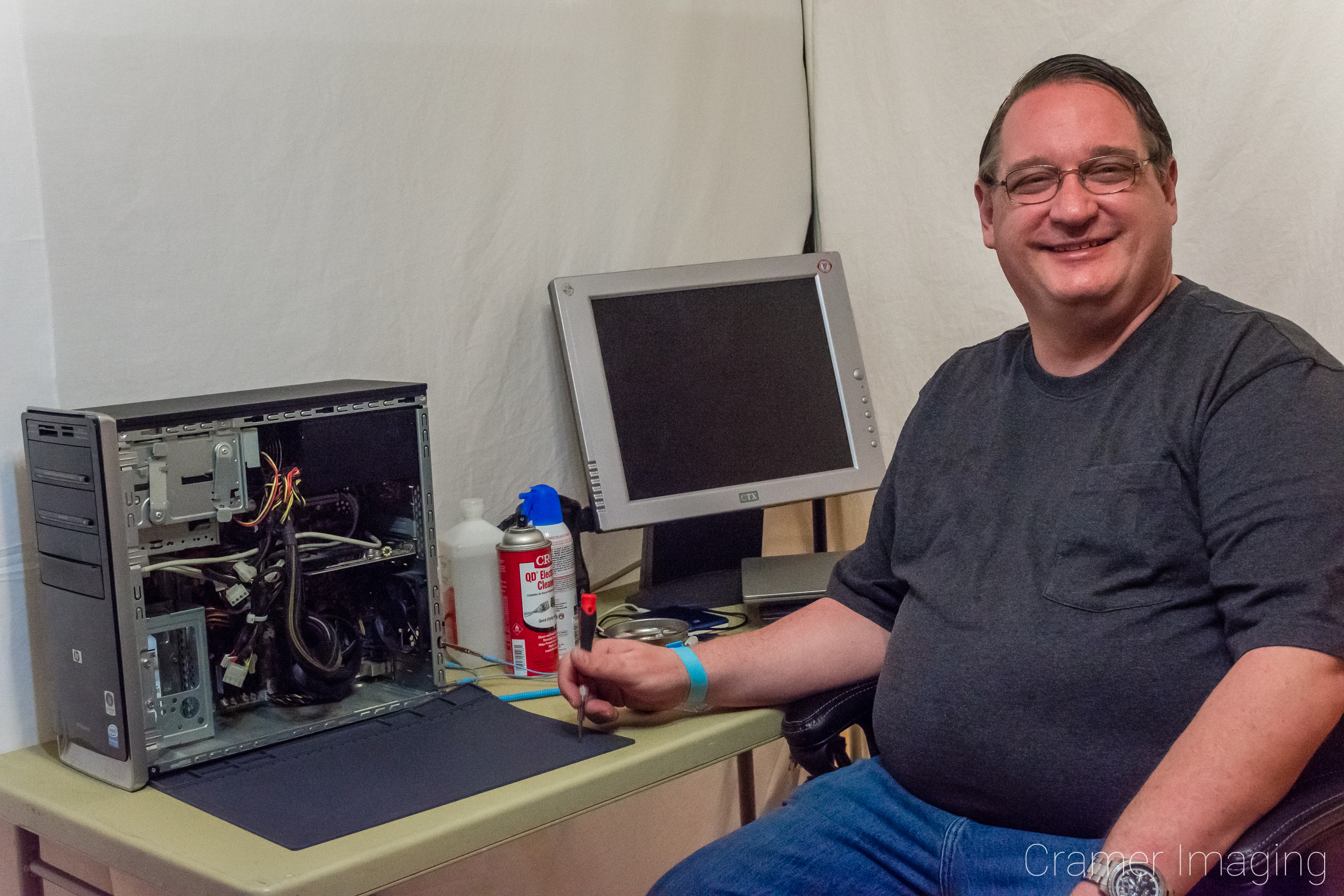 Computer tech Ken Cramer sitting at a computer repair station