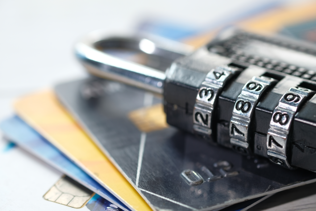 Photo of a combination lock sitting on top of a stack of credit cards