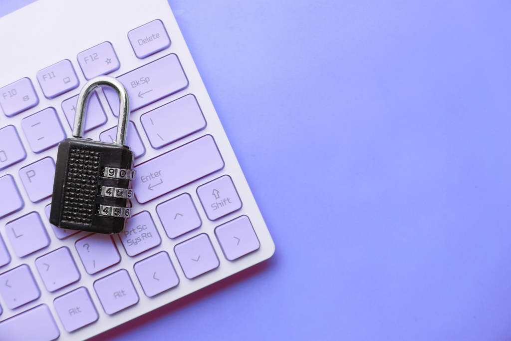 Photograph of an Apple keyboard with a black combination lock sitting on top